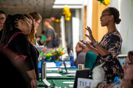 Tulane staff member talking to students about part-time employment